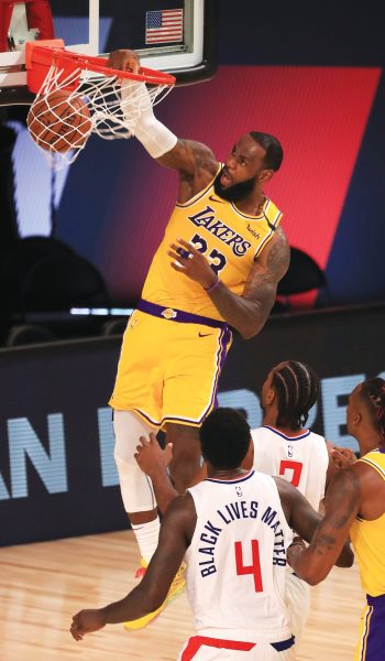 Los Angeles Lakers' LeBron James, top, dunks against the Los Angeles Clippers during the second quarter of an NBA basketball game Thursday, July 30, 2020, in Lake Buena Vista, Fla. (Mike Ehrmann/Pool Photo via AP)