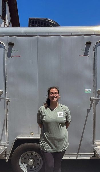 Kelsey Lynch in front of mobile showers